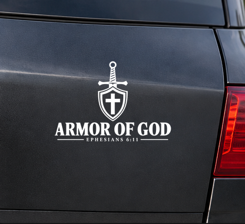 White Armor of God Christian vinyl decal displayed on the rear window of a dark SUV, featuring a sword design and Ephesians 6:11.