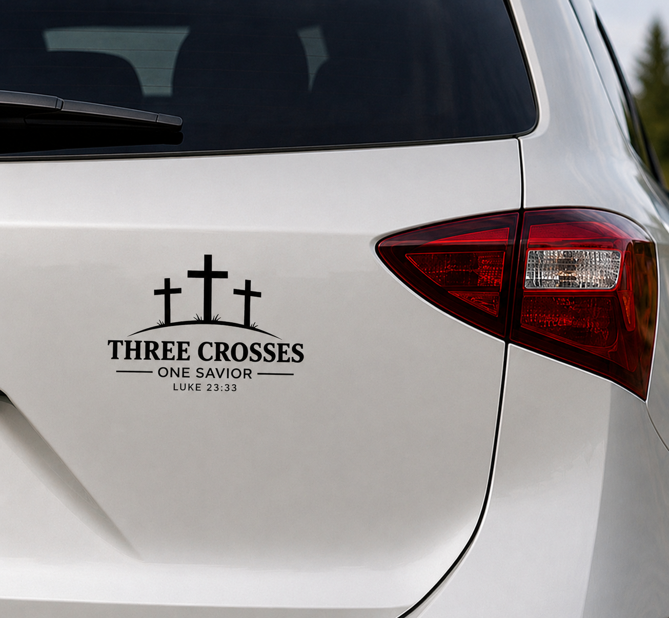 Three Crosses One Savior Christian vinyl decal in black displayed on the rear body panel of a white vehicle.