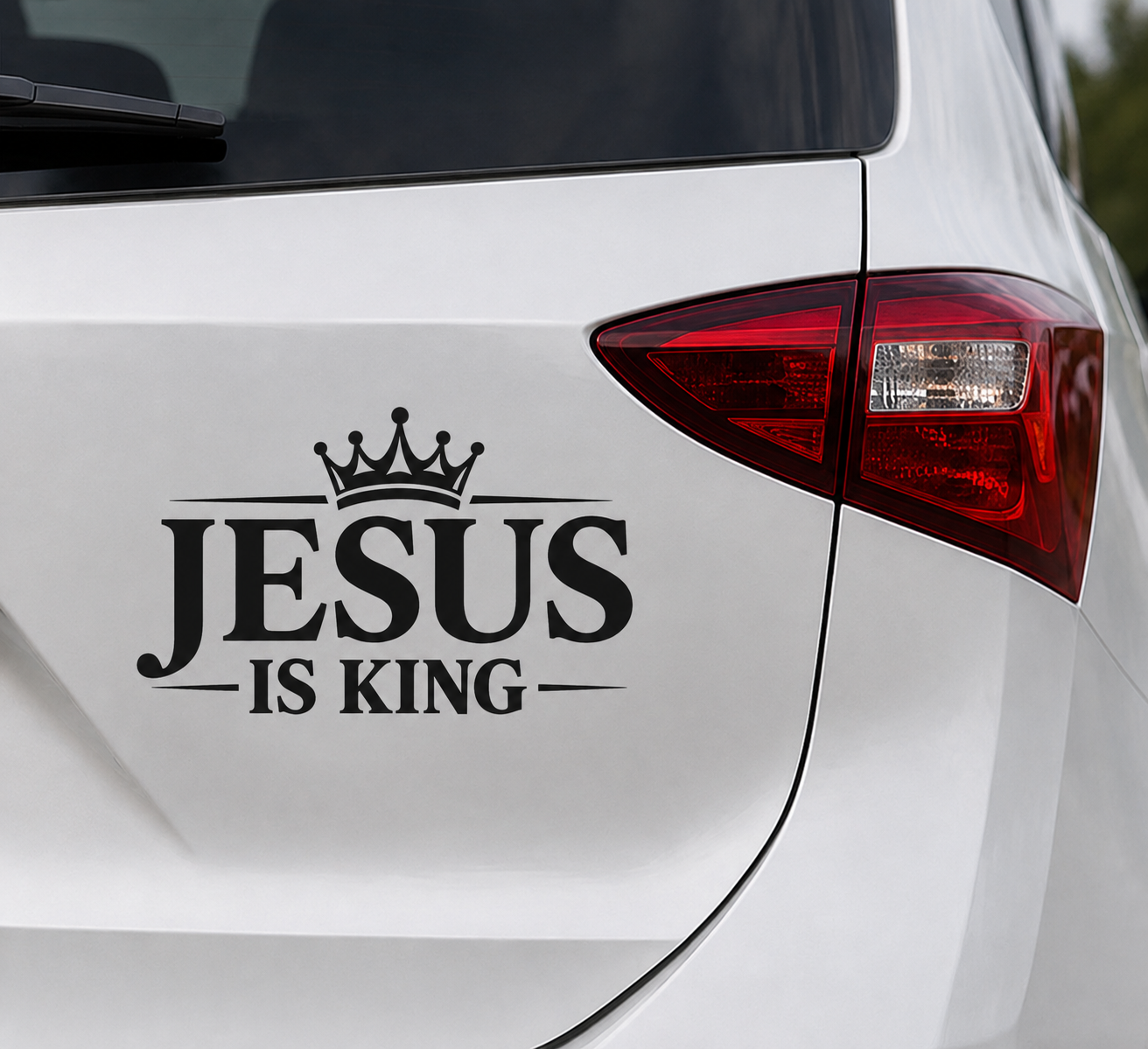Jesus Is King Christian car decal applied to a white vehicle body panel