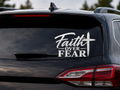 White Faith Over Fear Christian vinyl decal with cross displayed on rear SUV window