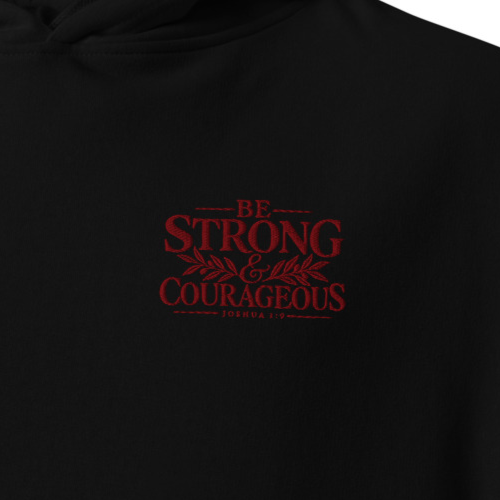 Close-up of black Be Strong & Courageous Joshua 1:9 premium embroidered Christian hoodie with red botanical chest embroidery.