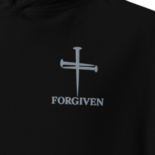 Close-up of black Forgiven premium embroidered Christian hoodie with silver cross and chest embroidery.