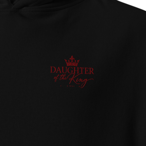 Close-up of black Daughter of the King premium embroidered Christian hoodie with red crown and script chest embroidery.