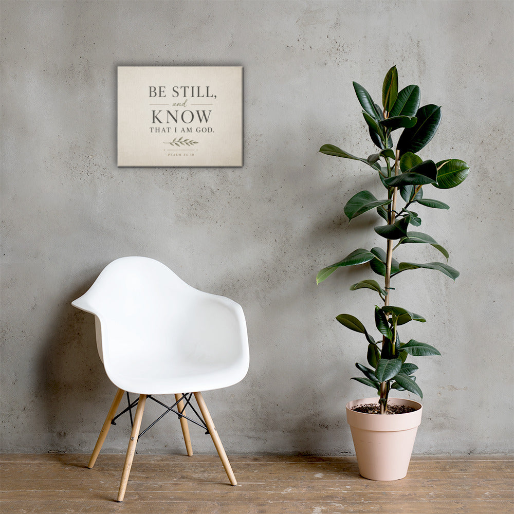Psalm 46:10 Christian wall art displayed in bright neutral interior with chair and houseplant