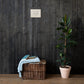 Be Still and Know Christian Scripture canvas displayed on dark wood wall above basket and plant
