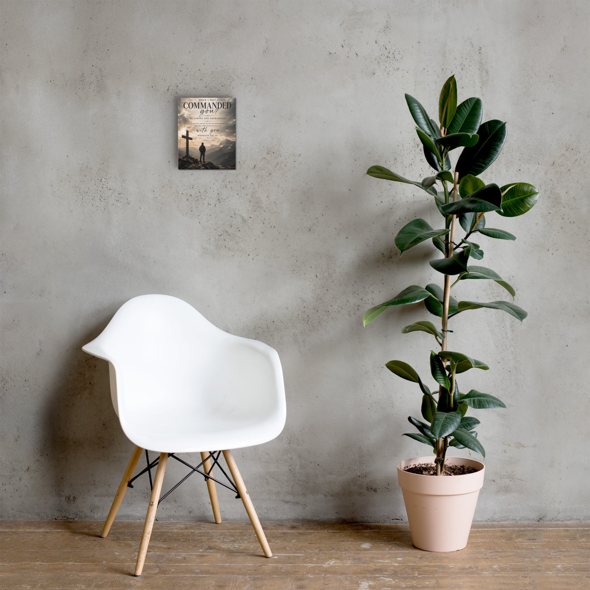 Be Strong and Courageous Joshua 1:9 Bible verse canvas displayed with white chair and plant