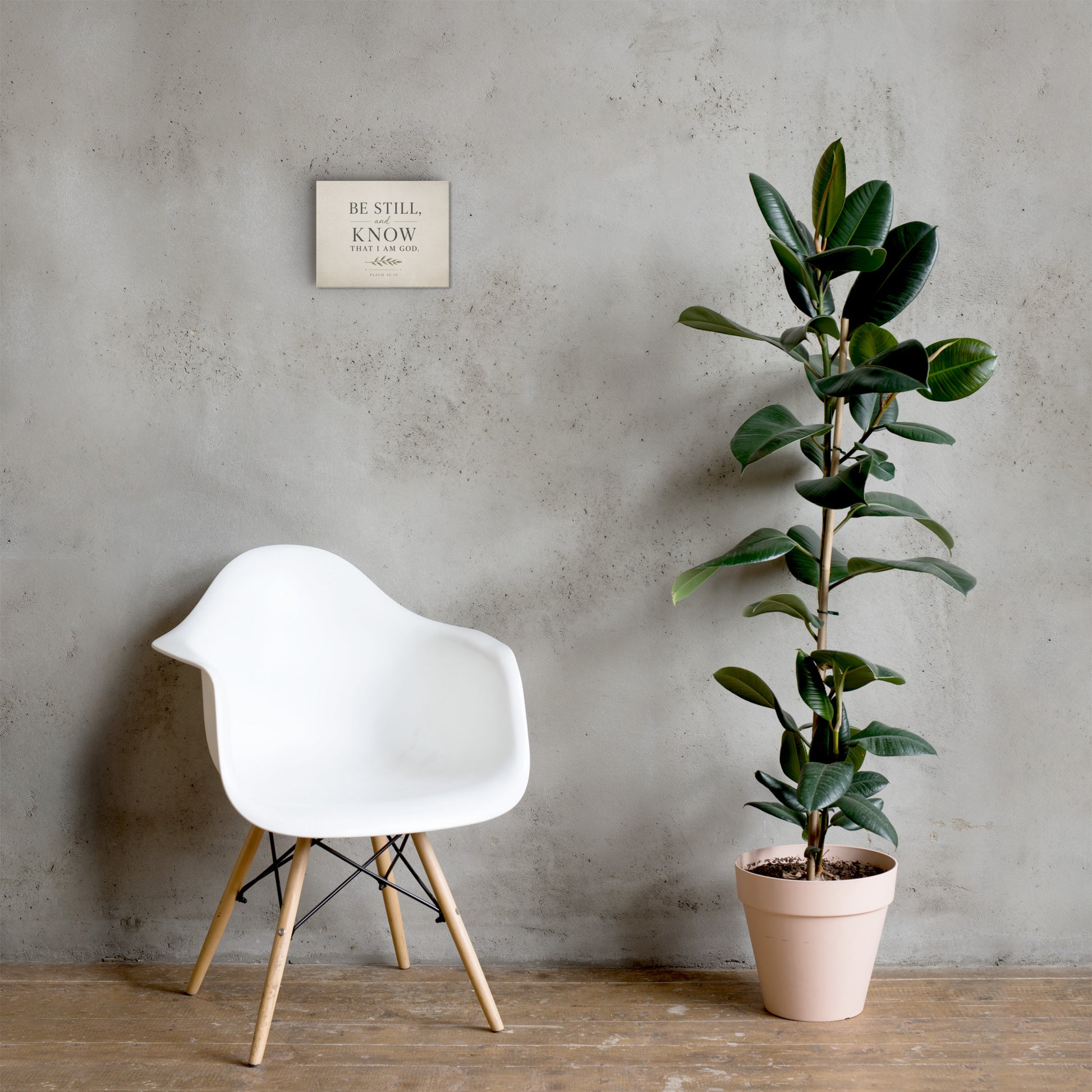 Psalm 46:10 Be Still and Know Christian canvas displayed in neutral room with chair and plant