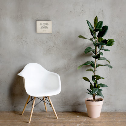 Psalm 46:10 Be Still and Know Christian canvas displayed in neutral room with chair and plant