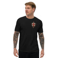 Man wearing black Stand Firm Christian T-shirt with red cross shield left-chest insignia